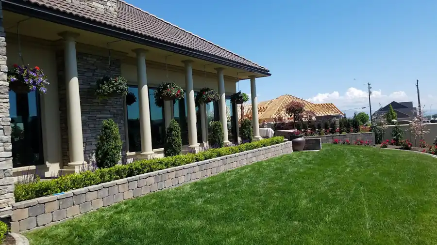 Block planter wall and lawn at a columned commercial building